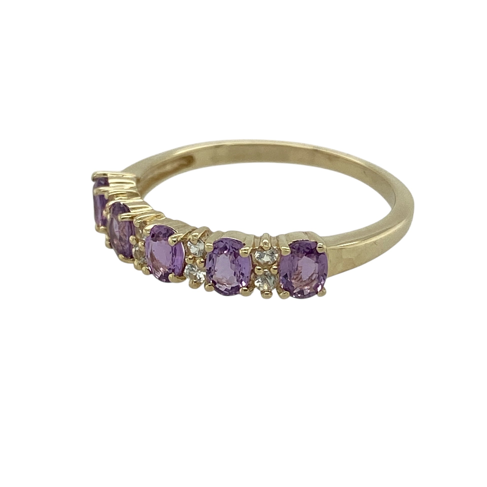 Bring rich colour and refined sparkle to your jewellery collection with this pre-owned 9ct yellow gold amethyst & white topaz set band ring, a graceful design with timeless appeal.

Design: The ring features oval amethyst stones, each measuring approximately 4mm by 3mm, accented with white topaz stones that add subtle brilliance and balance to the band.
Material: Made from polished 9-carat yellow gold, the warm tone beautifully complements the deep purple of the amethyst and the sparkle of the white topaz.
