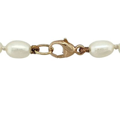 Bring classic elegance and soft lustre to your jewellery collection with this pre-owned 9ct yellow gold and pearl ball necklace, a timeless piece with refined charm.

Design: This necklace features a series of smooth pearl ball details arranged along the chain, creating a graceful and balanced look with traditional appeal.
Material: Made from 9-carat yellow gold, the warm polished finish beautifully complements the natural sheen of the pearls.
