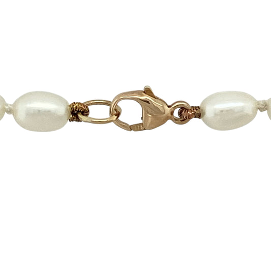 Bring classic elegance and soft lustre to your jewellery collection with this pre-owned 9ct yellow gold and pearl ball necklace, a timeless piece with refined charm.

Design: This necklace features a series of smooth pearl ball details arranged along the chain, creating a graceful and balanced look with traditional appeal.
Material: Made from 9-carat yellow gold, the warm polished finish beautifully complements the natural sheen of the pearls.