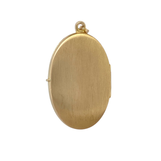 Bring elegant colour and sentimental charm to your jewellery collection with this pre-owned 9ct yellow gold and blue topaz set patterned oval locket.

Design: The locket features a classic oval shape with decorative patterned detailing, highlighted by an oval blue topaz measuring approximately 7mm by 5mm at the front for a subtle touch of colour.
Material: Made from 9-carat yellow gold, the warm polished finish beautifully complements the soft blue tones of the topaz.