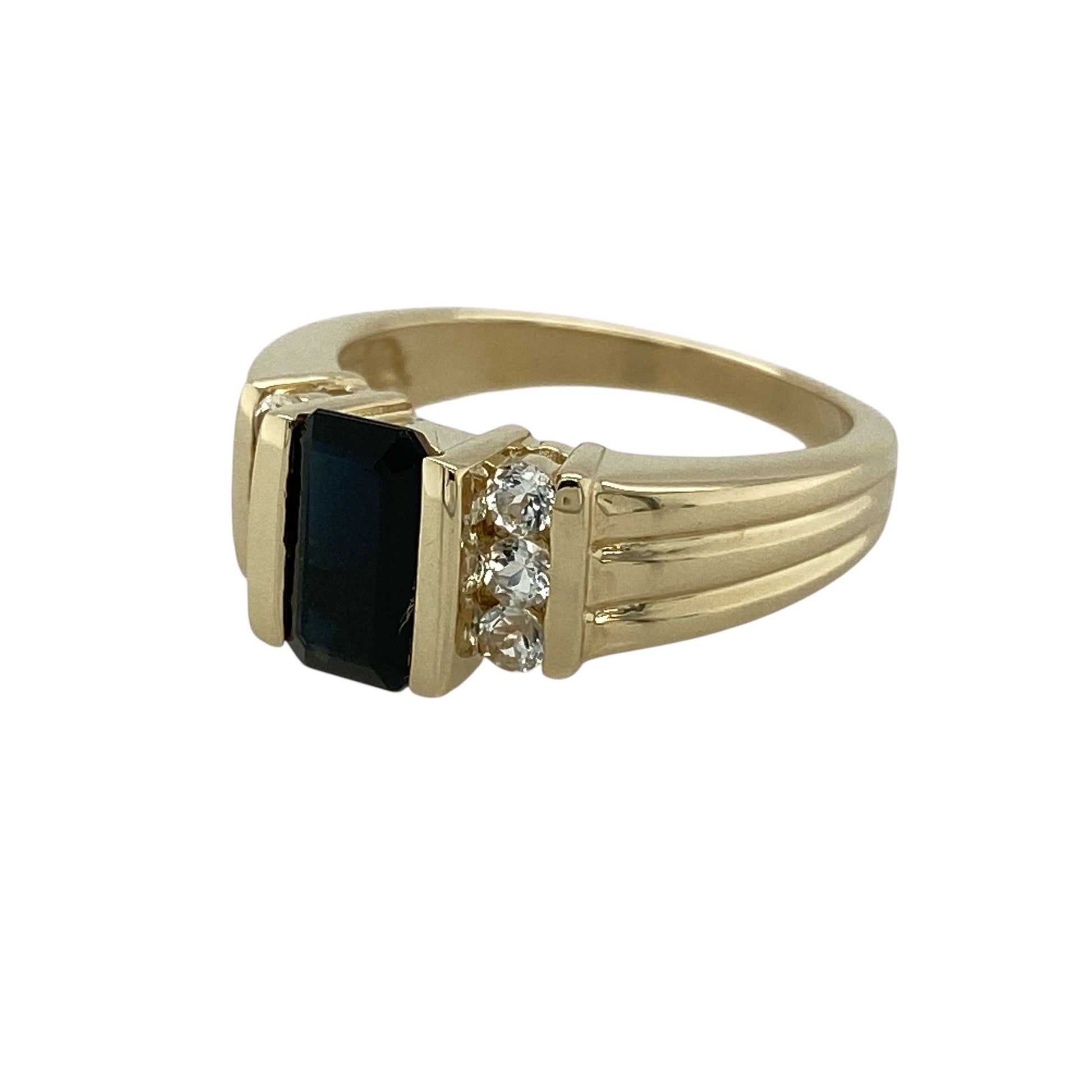 Bring rich colour and refined sparkle to your jewellery collection with this pre-owned 9ct yellow gold indicolite and white topaz set ring.

Design: The ring features a rectangular indicolite stone at the centre, measuring approximately 8mm by 5mm, forming a striking focal point, with white topaz stones accenting the design for added brilliance.