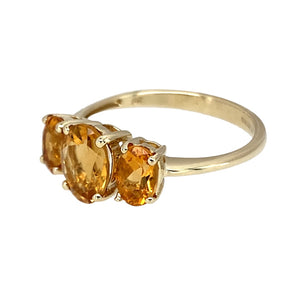 Preowned 9ct Yellow Gold & Citrine Trilogy Ring in size Q with the weight 2.40 grams. The center stone is 8mm by 6mm and the side stones are each 6mm by 4mm