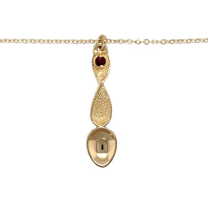 Preowned 9ct Yellow Gold & Garnet Set Lovespoon Pendant on an 18" trace chain with the weight 3.50 grams. The pendant is 3.7cm long including the bail and the garnet stone is 3mm diameter 