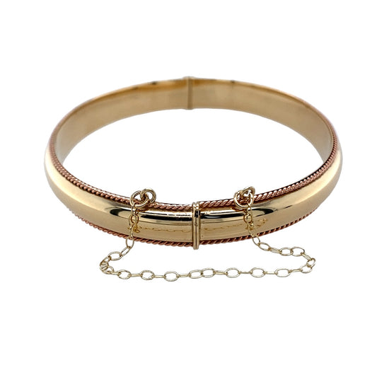 Bring elegance, heritage, and timeless craftsmanship to your collection with this pre-owned 9ct yellow and rose Cymru Welsh gold hinged bangle—a beautifully detailed piece inspired by classic design and Welsh tradition.

Design: The bangle features an intricate rope-style pattern that flows seamlessly around the wrist, highlighted by the soft contrast of yellow and rose gold tones. Its hinged design ensures both style and practicality, offering ease of wear and a secure fit.