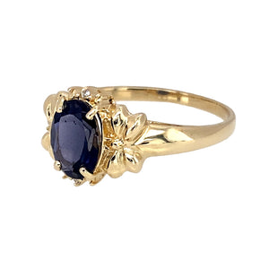 Preowned 9ct Yellow Gold & Dark Indigo Stone Set Ring in size N with the weight 2.20 grams. The indigo stone is 8mm by 6mm