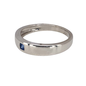 Preowned 9ct White Gold & Sapphire Set Band Ring in size L with the weight 2.50 grams. The front of the band is 4mm wide and the sapphire stone is 2mm by 2mm