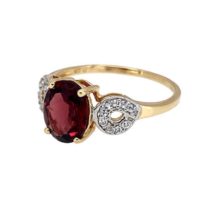 Preowned 10ct Yellow and White Gold Garnet & Cubic Zirconia Set Ring in size P to Q with the weight 2.30 grams. The garnet coloured stone stone is 9mm by 7mm