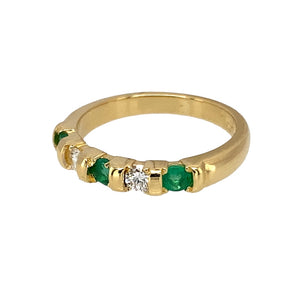 Preowned 18ct Yellow Gold Diamond & Emerald Set Band Ring in size I with the weight 3 grams. The emerald stones are each approximately 3mm diameter