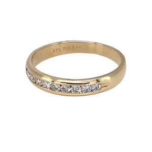 Preowned 9ct Yellow Gold & Diamond Set Band Ring in size L with the weight 1.50 grams. There is approximately 25pt of diamond content in total and the band is 3mm wide