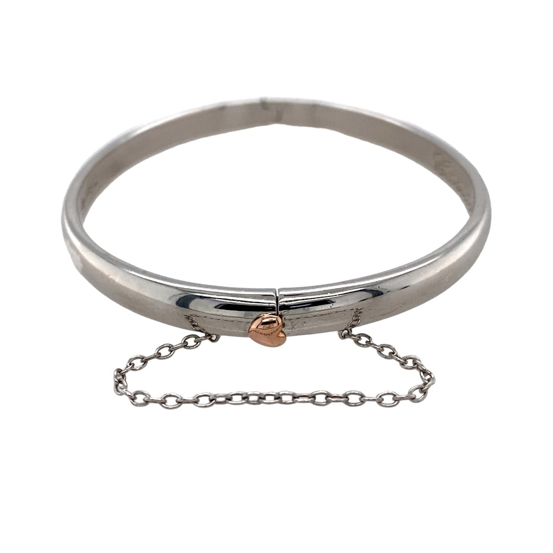 Preowned 925 Silver with 9ct Rose Gold Cariad Heart Hinge Bangle with the weight 19.40 grams. The bangle width is 5mm wide and the bangle diameter is 6cm
