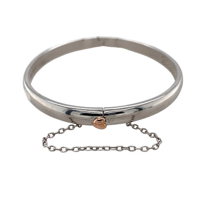Preowned 925 Silver with 9ct Rose Gold Cariad Heart Hinge Bangle with the weight 19.40 grams. The bangle width is 5mm wide and the bangle diameter is 6cm