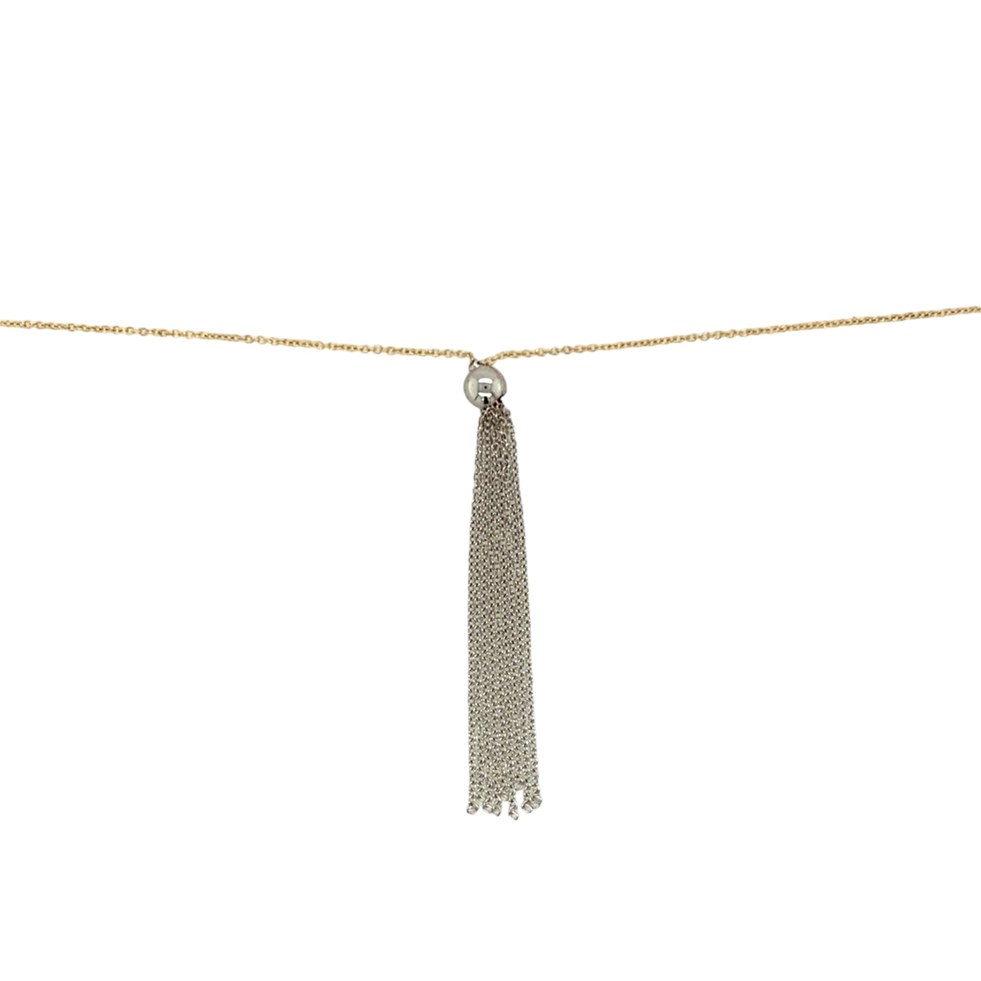 Preowned 18ct Yellow and White Gold 18" Ball Tassel Necklace with the weight 2.80 grams. The white gold ball is 5mm diameter
