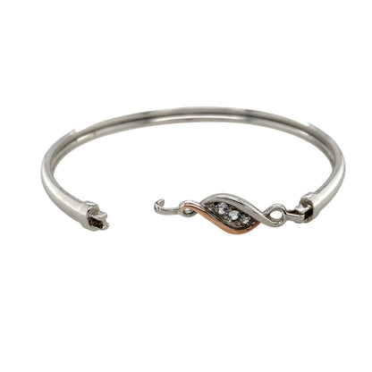 Add a meaningful and elegant piece to your jewellery collection with this pre-owned 925 silver with 9ct rose gold & white topaz set Clogau 'Past, Present, and Future' bangle, featuring:

Design: A sophisticated bangle symbolising Past, Present, and Future, representing love and connection through time.
Material: A combination of 925 sterling silver and 9-carat rose gold, creating a beautiful two-tone contrast.
Gemstones: Set with three white topaz stones, each measuring 3mm in diameter
