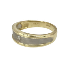 Load image into Gallery viewer, Add a touch of sophistication to your jewellery collection with this pre-owned 9ct yellow and white gold &amp; diamond set band ring, featuring:

Design: A stylish two-tone band with a classic and elegant appeal.
Material: 9-carat yellow and white gold, creating a beautiful contrast and refined finish.
Gemstone Detail: Features a single brilliant-cut diamond set at the center, adding a touch of sparkle.
Ring Width: The front of the band measures 7mm wide, making a bold yet sophisticated statement.


