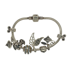 Add a sentimental and stylish piece to your jewellery collection with this pre-owned 925 silver 7" charm bracelet, featuring:

Design: A meaningful charm bracelet, adorned with a variety of symbolic charms.
Material: 925 sterling silver, offering a high-quality and polished finish.
Bracelet Length: Measures 7 inches, providing a comfortable and secure fit.
Charms Included: Features heartfelt charms engraved with "Family," "Mum," and "Care," alongside a dog, angel wing, and more