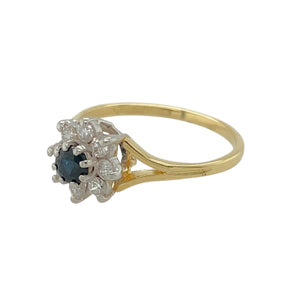 Add a touch of elegance and charm to your jewellery collection with this pre-owned 18ct yellow gold diamond and sapphire set flower cluster ring.

Design: Featuring a delicate flower cluster design, this ring is centred around a round sapphire stone, surrounded by sparkling diamonds for added brilliance.
Material: Made from 18-carat yellow gold, offering a warm, polished finish that enhances the beauty of the sapphires and diamonds.
