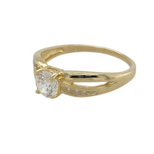 Load image into Gallery viewer, Add a touch of brilliance to your jewellery collection with this pre-owned 9ct yellow gold and cubic zirconia set solitaire ring.

Design: A classic solitaire ring featuring a dazzling centre stone, complemented by sparkling cubic zirconia set along the shoulders for added elegance.
Material: Made from 9-carat yellow gold, offering a warm and polished finish that enhances the brilliance of the stones.
Gemstone Detail: The centre cubic zirconia stone measures 5mm in diameter
