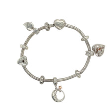Load image into Gallery viewer, Add a meaningful and elegant touch to your jewellery collection with this pre-owned 925 silver Clogau charm bracelet with 9ct rose gold accents.

Design: This stunning charm bracelet features a heart-shaped Tree of Life charm, a moon with star charm, another Tree of Life heart charm, and a heart charm, symbolising love, nature, and the celestial. Five stoppers are included to keep the charms spaced out and secure.
Material: Made from 925 silver with 9ct rose gold accents
