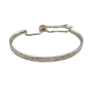 Add a touch of sophistication and luxury to your jewellery collection with this pre-owned 925 silver with 9ct rose gold and diamond-set Clogau patterned bangle.

Design: This bangle features intricate Clogau patterned detailing, paired with the warmth of 9ct rose gold accents. The adjustable heart clasp adds a unique and stylish feature, with two small diamonds set inside for added sparkle.
Material: Crafted from 925 silver with 9ct rose gold, this bangle offers a beautiful combination of traditional crafts