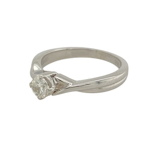 Add a touch of elegance to your jewellery collection with this pre-owned 9ct white gold diamond set solitaire ring.

Design: A classic solitaire design with a stunning center diamond, enhanced by a unique twist detail on the shoulders, creating a modern yet timeless look.
Material: Made from 9-carat white gold, offering a sleek and polished finish that complements the brilliance of the diamond.
Gemstone Detail: The center diamond is approximately 0.25ct, providing a delicate and captivating sparkle.
