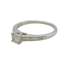 Load image into Gallery viewer, Add a touch of elegance to your jewellery collection with this pre-owned 9ct white gold diamond set solitaire ring.

Design: A timeless solitaire design featuring a stunning center diamond, complemented by diamonds set on the shoulders for added brilliance and sophistication.
Material: Made from 9-carat white gold, providing a sleek and polished finish that enhances the sparkle of the diamonds.
Gemstone Detail: The center diamond is approximately 0.25ct, with additional diamonds set on the shoulders to add 
