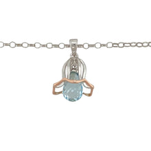 Load image into Gallery viewer, Add a touch of nature-inspired elegance to your jewellery collection with this pre-owned 925 silver with 9ct rose gold and blue stone flower Clogau pendant.

Design: Featuring a beautiful flower design adorned with a vibrant blue stone, this pendant captures the essence of nature, with delicate 9ct rose gold accents for added elegance.
Material: Made from 925 sterling silver with 9ct rose gold, the pendant is complemented by a striking blue stone that brings depth and color to the design.

