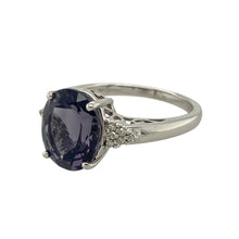 Load image into Gallery viewer, Add striking elegance to your jewellery collection with this pre-owned 9ct white gold diamond and deep purple/blue coloured stone dress ring, featuring:

Design: A bold and elegant dress ring with a richly coloured centre stone framed by sparkling diamond accents.
Material: 9-carat white gold, offering a sleek, polished finish that enhances the cool tones of the design.
Gemstone Detail: Features an 11mm by 9mm deep purple/blue coloured stone, accented with diamonds for added brilliance.

