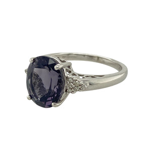 Add striking elegance to your jewellery collection with this pre-owned 9ct white gold diamond and deep purple/blue coloured stone dress ring, featuring:

Design: A bold and elegant dress ring with a richly coloured centre stone framed by sparkling diamond accents.
Material: 9-carat white gold, offering a sleek, polished finish that enhances the cool tones of the design.
Gemstone Detail: Features an 11mm by 9mm deep purple/blue coloured stone, accented with diamonds for added brilliance.
