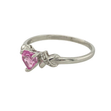 Load image into Gallery viewer, Add a romantic and elegant piece to your jewellery collection with this pre-owned 9ct white gold heart ring, featuring:

Design: A delicate heart-shaped design, centred with a pink sapphire and accented by sparkling diamonds for a graceful finish.
Material: 9-carat white gold, offering a sleek and contemporary shine.
Gemstone Detail: A vibrant 5mm heart-shaped pink sapphire takes centre stage, enhanced by diamond accents that add brilliance and charm.

