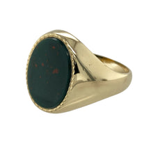 Load image into Gallery viewer, Add a bold and distinguished piece to your jewellery collection with this pre-owned 9ct yellow gold signet ring, featuring:

Design: A classic oval signet style that exudes timeless sophistication, perfect for everyday wear or special occasions.
Material: 9-carat yellow gold, offering a rich and enduring finish.
Gemstone Detail: Set with a deep green bloodstone measuring 16mm by 12mm, known for its subtle red flecks and strong presence.

