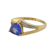 Load image into Gallery viewer, Add bold colour and contemporary flair to your collection with this pre-owned 18ct yellow gold tanzanite ring, featuring:

Design: A modern and striking design centred around a unique triangular-cut tanzanite, offering a fresh twist on classic gemstone settings.
Material: 18-carat yellow gold, known for its rich tone and luxurious finish.
Gemstone Detail: Set with a vibrant 7mm by 7mm by 7mm triangular tanzanite, showcasing a vivid violet-blue hue and eye-catching shape.

