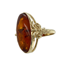Load image into Gallery viewer, Add warmth and vintage charm to your jewellery collection with this pre-owned 9ct yellow gold amber set ring, featuring:

Design: A bold long oval setting that showcases the natural beauty of amber, offering a statement look with timeless elegance.
Material: 9-carat yellow gold, complementing the amber’s rich golden tones with a smooth, polished finish.
Gemstone Detail: Features a 23mm by 10mm long oval amber stone, known for its warm glow and organic inclusions that make each piece unique.

