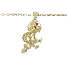 Load image into Gallery viewer, Unleash bold energy and mythical style with this pre-owned 9ct yellow gold oriental dragon pendant necklace, featuring:

Design: An intricately detailed oriental-style dragon, symbolising strength, power, and good fortune—complete with ruby-coloured red stones set as striking eyes.
Material: 9-carat yellow gold, offering a polished finish that enhances the texture and fine details of the dragon’s form.
Gemstone Detail: Set with vivid red ruby-coloured stones for eyes, adding a fierce and captivating accent.
