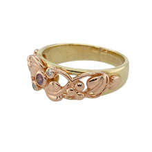 Load image into Gallery viewer, Celebrate life, love, and legacy with this pre-owned 9ct yellow and rose gold Clogau Tree of Life ring, featuring:

Design: A flowing Tree of Life design symbolising growth, strength, and continuity—crafted in a beautiful blend of yellow and rare Welsh rose gold.
Material: 9-carat yellow and rose gold, with delicate detailing that reflects Clogau’s signature heritage-inspired craftsmanship.
Gemstone Detail: Set with a 2mm pink tourmaline at the heart of the design, flanked by two small sparkling diamonds
