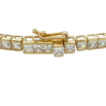 Load image into Gallery viewer, Add timeless sparkle and refined elegance to your jewellery collection with this pre-owned 9ct yellow gold and cubic zirconia set tennis bracelet, designed to dazzle with every movement, featuring:

Design: A classic 8-inch tennis bracelet showcasing a continuous line of square-cut stones, offering a sleek and symmetrical silhouette that exudes sophistication.
Material: Crafted in 9-carat yellow gold, the warm, polished setting perfectly complements the brilliance of the cubic zirconia.
