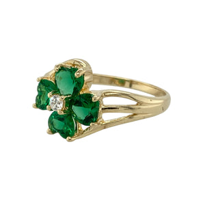 Add a pop of colour and floral charm to your jewellery collection with this pre-owned 9ct yellow gold green stone and cubic zirconia set flower ring, blending playful elegance with timeless sparkle, featuring:

Design: A striking flower-shaped arrangement made up of heart-shaped green stones forming the petals, accented with cubic zirconia at the centre for added brilliance and detail.
Material: Made from 9-carat yellow gold