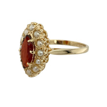 Load image into Gallery viewer, Add a touch of antique-style elegance to your collection with this pre-owned 9ct yellow gold garnet and seed pearl set cluster ring, combining deep colour with delicate detail, featuring:

Design: A refined cluster style ring centred around a marquise-cut garnet, framed by a halo of seed pearls for a timeless, vintage-inspired look.
Material: Made from 9-carat yellow gold, the polished finish enhances the rich tones of the garnet and the soft lustre of the pearls.

