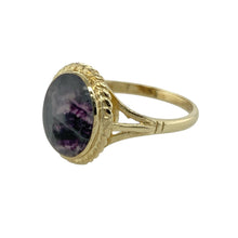 Load image into Gallery viewer, Showcase natural beauty and unique British heritage with this pre-owned 9ct yellow gold Blue John set ring, featuring a richly coloured stone framed in classic detail, perfect for lovers of timeless and earthy style, featuring:

Design: A traditional setting with an oval cabochon Blue John stone, framed by a rope-edged surround that adds texture and vintage charm to the piece.
Material: Made from 9-carat yellow gold, the warm tone enhances the natural veining and deep hues of the Blue John stone.
