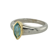 Load image into Gallery viewer, Add a touch of refined elegance and vibrant colour to your collection with this pre-owned 18ct white gold diamond and blue topaz set ring, blending high-quality materials with timeless design, featuring:

Design: A graceful marquise-cut blue topaz is set in yellow gold at the centre, creating a beautiful contrast against the white gold band, which is accented with two small diamonds on either side for added sparkle.
Material: Made from luxurious 18-carat white gold

