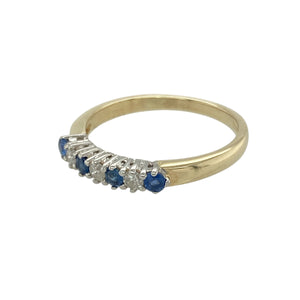 Add a hint of classic charm and rich colour to your jewellery collection with this pre-owned 9ct yellow gold diamond and sapphire set band ring, perfect for stacking or wearing alone, featuring:

Design: A refined band style with a subtle row of alternating sapphires and diamonds, offering timeless elegance in a clean, understated setting.
Material: Made from 9-carat yellow gold, the polished finish enhances the warmth of the metal and the brilliance of the stones.