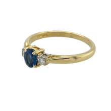 Load image into Gallery viewer, Celebrate classic beauty and meaningful design with this pre-owned 18ct yellow gold diamond and sapphire set trilogy ring, symbolising the past, present, and future with refined elegance, featuring:

Design: A timeless trilogy style showcasing a rich sapphire at the centre, flanked by two brilliant-cut diamonds for a balanced and graceful look.
Material: Made from luxurious 18-carat yellow gold, the polished finish adds warmth and enhances the brilliance of the gemstones.

