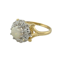 Load image into Gallery viewer, Add a touch of timeless elegance and iridescent beauty to your collection with this pre-owned 18ct yellow and white gold diamond and opal set cluster ring, offering classic charm and captivating colour play, featuring:

Design: A traditional cluster style ring with a central round opal surrounded by a halo of sparkling diamonds, creating a delicate yet striking floral-inspired silhouette.
Material: Made from 18-carat yellow and white gold, with the opal set in white gold to enhance its luminous tones
