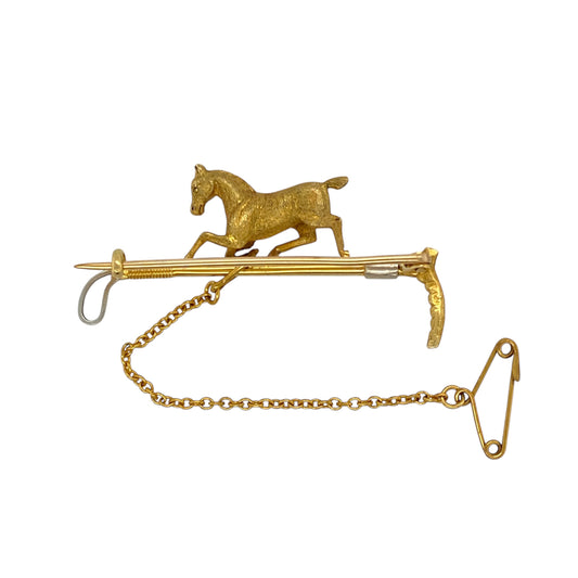Celebrate equestrian elegance with this pre-owned 15ct yellow gold vintage horse and riding crop pin, a finely detailed piece that captures timeless sporting heritage with refined craftsmanship, featuring:

Design: A beautifully sculpted horse head paired with a riding crop, brought to life with white gold detailing for added depth and contrast. A classic symbol of equestrian tradition, this pin is both a stylish accessory and a collector’s piece.
Material: Made from 15-carat yellow gold with white gold acc