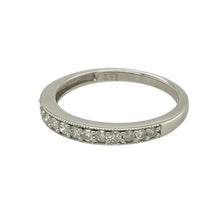 Load image into Gallery viewer, Add refined sparkle to your collection with this pre-owned 9ct white gold diamond set band ring, offering timeless elegance and subtle brilliance, perfect for stacking or wearing solo:

Design: A classic band style with a clean, polished profile, set with shimmering diamonds across the front for a touch of understated luxury.
Material: Made from 9-carat white gold, the sleek finish enhances the brilliance of the diamonds and gives the ring a contemporary edge.

