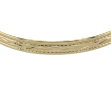 Load image into Gallery viewer, Bring sweet elegance to a little one&#39;s collection with this pre-owned 9ct yellow gold patterned children&#39;s expanding bangle, offering a timeless keepsake perfect for special occasions or everyday wear.

Design: The bangle features a classic expanding design with delicate engraved patterning, blending charm and tradition in a piece made to grow with its wearer.
Material: Made from 9-carat yellow gold, the polished finish enhances the soft glow of the gold and highlights the detailed surface design.

