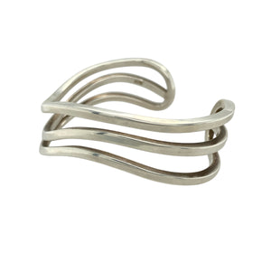 Bring sculptural elegance to your collection with this pre-owned 925 silver three band wave cuff bangle, offering a bold yet fluid design that combines modern style with timeless silver craftsmanship.

Design: The cuff features three flowing, wave-like bands that create a layered, openwork structure—offering movement, texture, and a distinctive silhouette.
Material: Made from 925 sterling silver, the polished finish enhances the fluid curves and gives the bangle a radiant, high-shine appearance.
