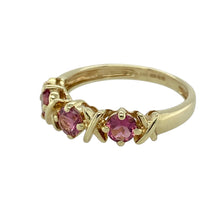 Load image into Gallery viewer, Bring romantic charm to your collection with this pre-owned 9ct yellow gold and pink stone band ring, featuring delicate design details and a soft splash of colour—perfect for gifting or everyday wear.

Design: The ring is set with three 4mm diameter pink stones, each accented with a subtle cross (kiss) shape at its centre, creating a sweet and symbolic look.
Material: Made from 9-carat yellow gold, the polished finish enhances the warmth of the gold and complements the gentle hue of the pink stones.

