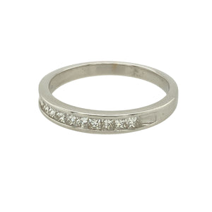 Bring refined sparkle to your collection with this pre-owned 18ct white gold diamond set band ring, offering clean lines and contemporary elegance—perfect for everyday luxury or meaningful milestones.

Design: The front of the band features a row of princess cut diamonds totalling approximately 0.25 carats, set in a sleek channel setting for a modern, seamless look.
Material: Made from 18-carat white gold, the polished finish enhances the crisp brilliance of the diamonds and adds a bright