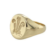 Load image into Gallery viewer, Bring proud tradition and bold style to your collection with this pre-owned 9ct gold Three Feathers oval signet ring, featuring classic heritage symbolism in a timeless design—perfect for everyday wear or meaningful gifting.

Design: The oval-shaped face showcases the iconic Welsh Three Feathers emblem, symbolising loyalty, strength, and national pride.
Material: Made from 9-carat gold, the polished finish highlights the rich tone of the gold and enhances the detail of the engraved emblem.

