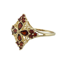Load image into Gallery viewer, Bring vintage-inspired beauty and rich colour to your collection with this pre-owned 9ct yellow gold garnet set filigree patterned ring, featuring intricate detail and timeless charm—perfect for statement styling or meaningful gifting.

Design: The ring showcases a deep red garnet stone set at the centre of an ornate 18mm high filigree front, with flowing openwork patterns that evoke antique elegance and fine craftsmanship.
